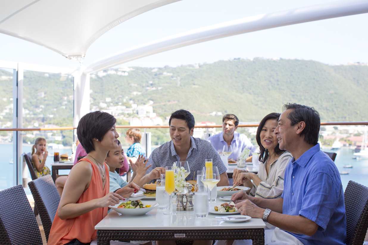 Guests eating in The Haven, Norwegian Escape